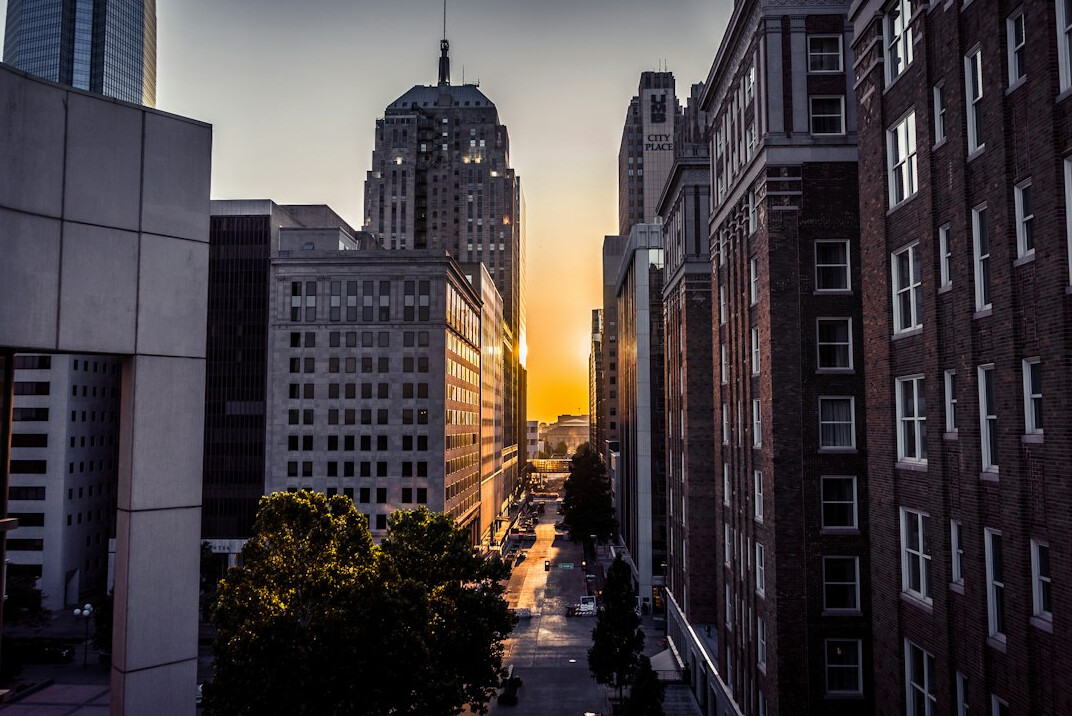 City buildings seen from the street at golden hour