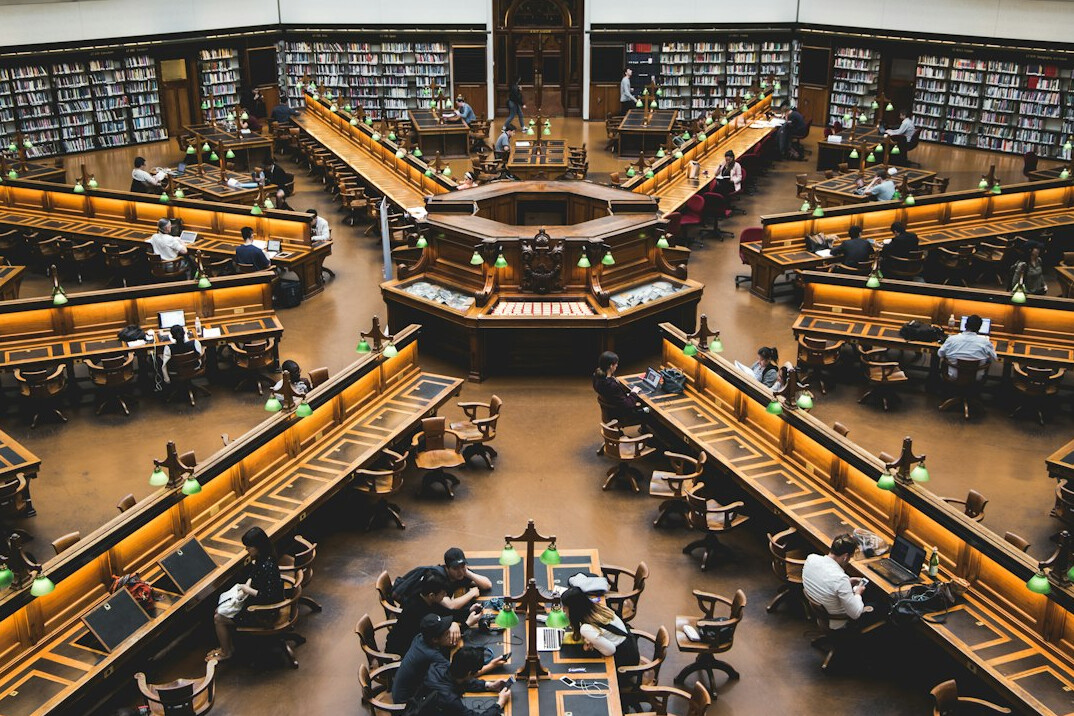 Library interior with bookshelves and reading tables