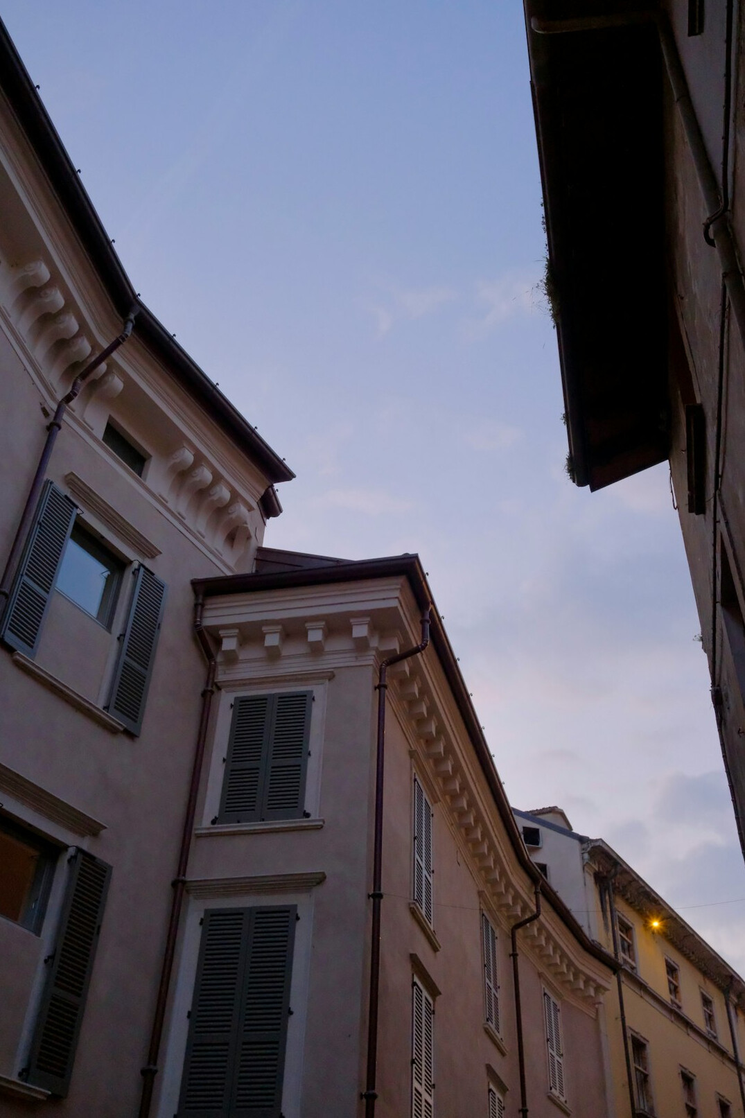 Old city street at dusk with historic buildings