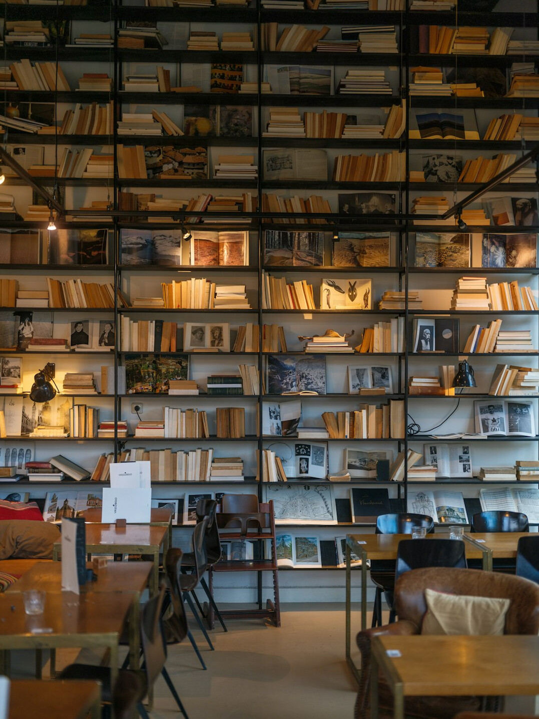 Rows of old books on a wooden shelf
