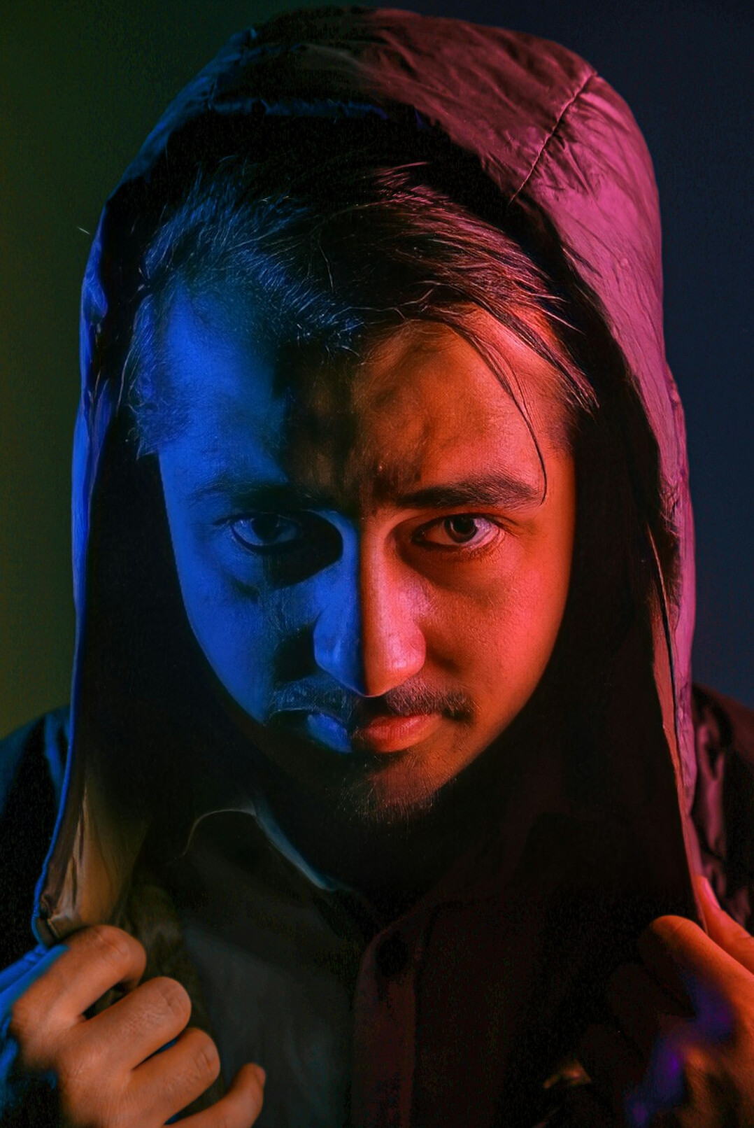 Portrait of a man in a dark jacket looking at camera